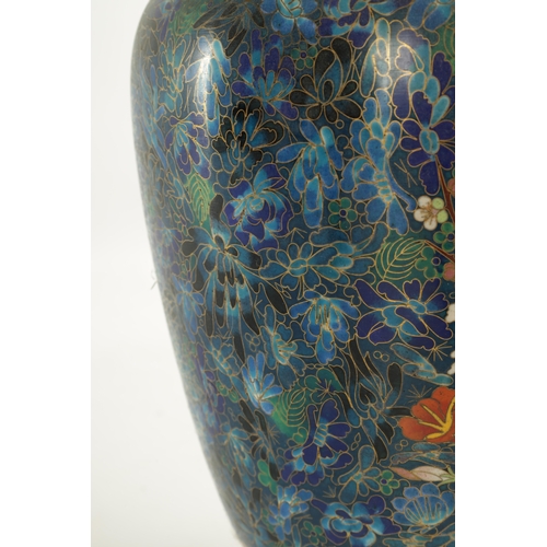 202 - A HIGHLY DECORATIVE AND COLOURFUL CHINESE CLOISONNE WARE HALL VASE with floral and geometric banded ... 