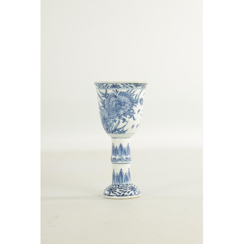 204 - A 19TH CENTURY CHINESE BLUE AND WHITE STEM CUP decorated with flowers and leaf work designs (15.5cm ... 