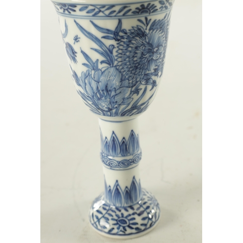 204 - A 19TH CENTURY CHINESE BLUE AND WHITE STEM CUP decorated with flowers and leaf work designs (15.5cm ... 