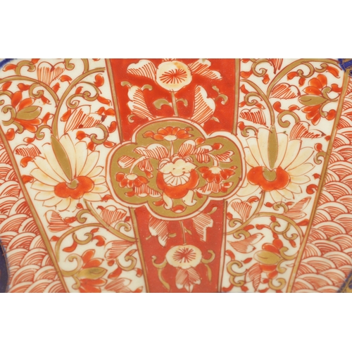 207 - A 19TH CENTURY IMARI CHARGER with a fluted border decorated with brightly coloured floral designs hi... 