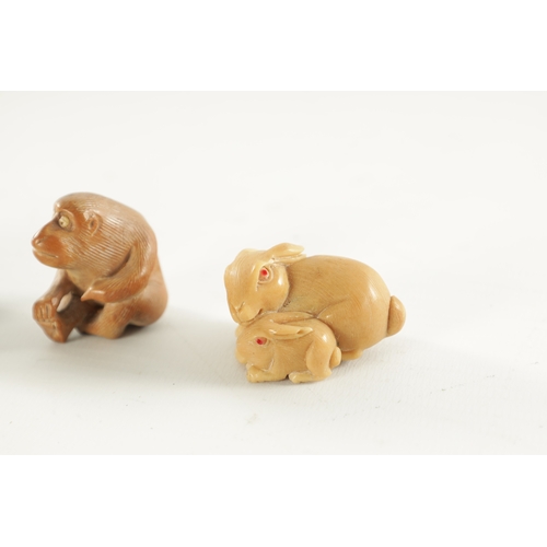 208 - TWO JAPANESE CARVED BOXWOOD NETSUKE AND A RESIN NETSUKE comprising of a water buffalo, monkey and a ... 