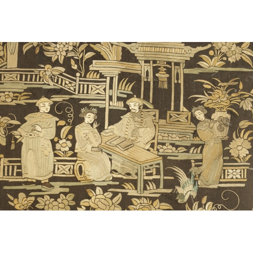 210 - AN EARLY 19TH CENTURY EMBROIDERED CHINESE PANEL depicting figures in a garden scene amongst foliage ... 