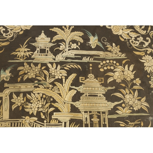 210 - AN EARLY 19TH CENTURY EMBROIDERED CHINESE PANEL depicting figures in a garden scene amongst foliage ... 