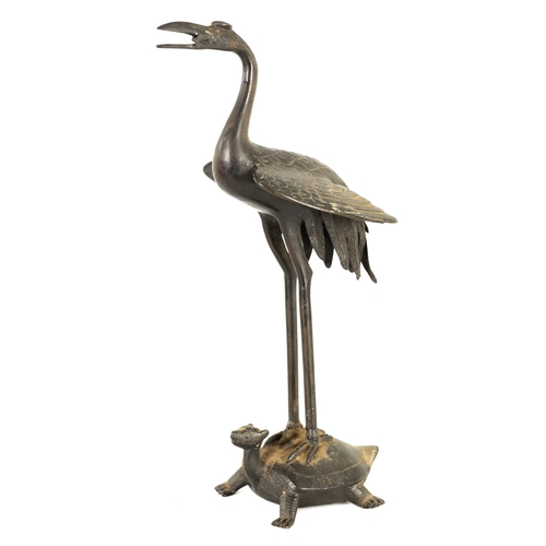 211 - A 19TH CENTURY JAPANESE BRONZE MODEL OF A CRANE standing on a turtle's back. (29cm tall)