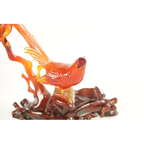 212 - A 19TH CENTURY CHINESE CARVED AGATE SCULPTURE OF A BIRD perched on branchwork on a hardwood base. (1... 