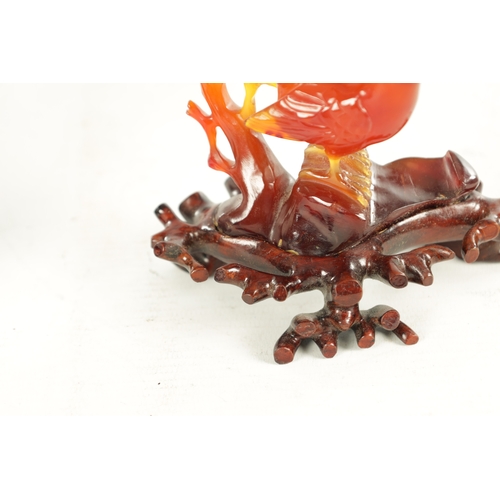 212 - A 19TH CENTURY CHINESE CARVED AGATE SCULPTURE OF A BIRD perched on branchwork on a hardwood base. (1... 