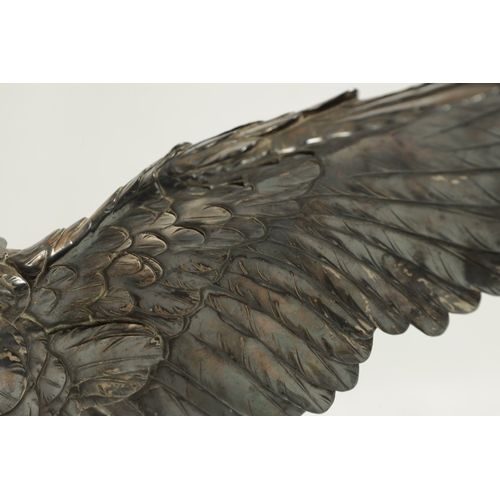 214 - A JAPANESE MEIJI PERIOD SILVERED BRONZE EAGLE SIGNED MASATSUNE realistically sculptured in a hoverin... 