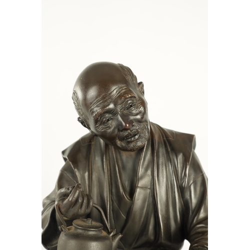 215 - A LARGE JAPANESE MEIJI PERIOD OKIMONO ON ROOT WOOD BASE depicting a robed elder seated with a teapot... 