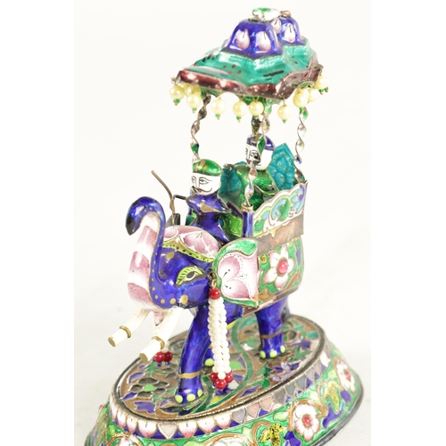 218 - A 20TH CENTURY INDIAN MEENAKARI SILVER AND COLOURED ENAMEL SCULPTURE of a standing elephant with how... 