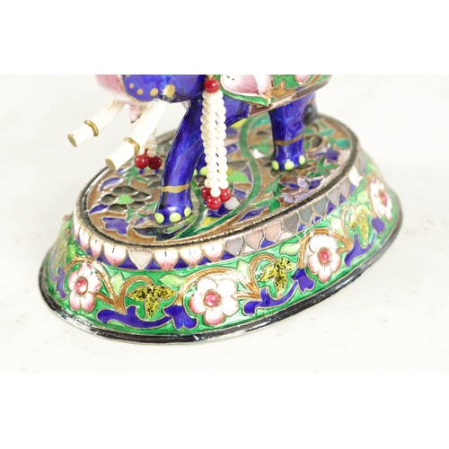 218 - A 20TH CENTURY INDIAN MEENAKARI SILVER AND COLOURED ENAMEL SCULPTURE of a standing elephant with how... 