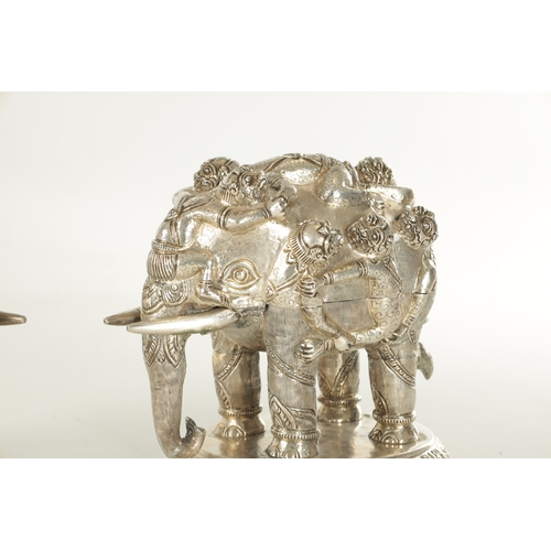 222 - A PAIR OF LATE 19TH CENTURY INDIAN SILVER SCULPTURES OF ELEPHANTS with relief moulded figures; raise... 