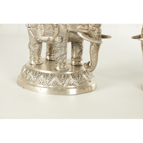 222 - A PAIR OF LATE 19TH CENTURY INDIAN SILVER SCULPTURES OF ELEPHANTS with relief moulded figures; raise... 