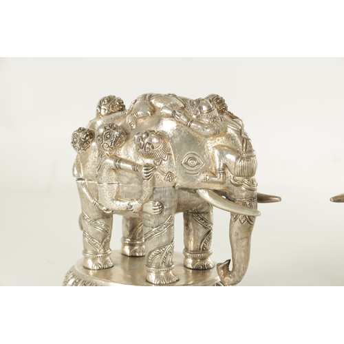 222 - A PAIR OF LATE 19TH CENTURY INDIAN SILVER SCULPTURES OF ELEPHANTS with relief moulded figures; raise... 