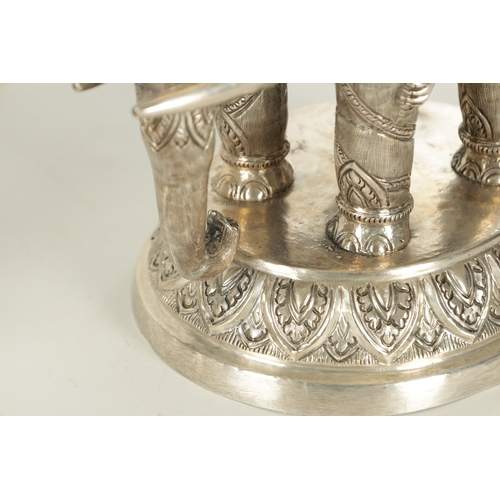 222 - A PAIR OF LATE 19TH CENTURY INDIAN SILVER SCULPTURES OF ELEPHANTS with relief moulded figures; raise... 