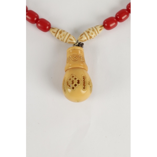 229 - A JAPANESE RED CORAL AND IVORY NECKLACE with pierced shaped pendant. Ivory Act 2018 Exemption Submis... 