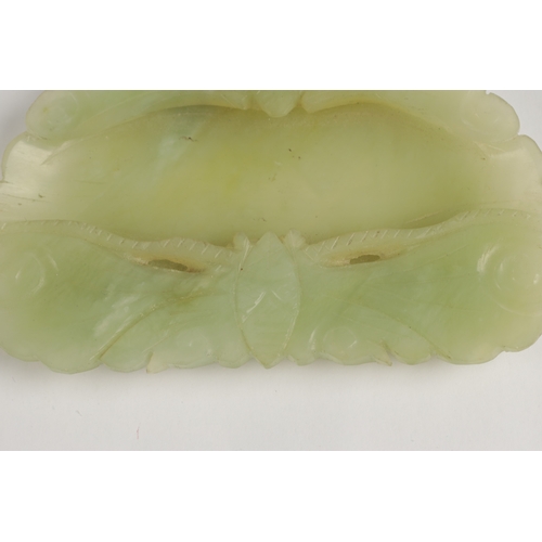 238 - A CHINESE PALE GREEN CARVED JADE BRUSH WASHER, modelled as two bats surrounding a shallow well. (10.... 