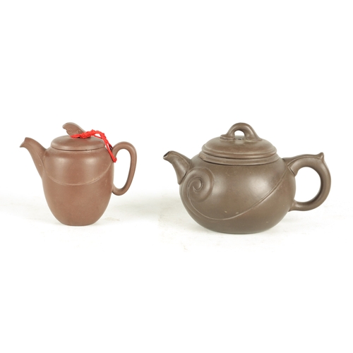 239 - TWO CHINESE TERRACOTTA TEAPOTS with scrolled embossed bodies and impressed mark to underside (9cm hi... 