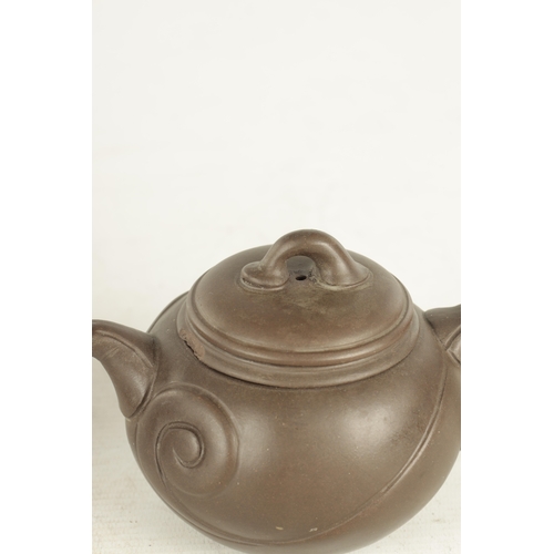 239 - TWO CHINESE TERRACOTTA TEAPOTS with scrolled embossed bodies and impressed mark to underside (9cm hi... 