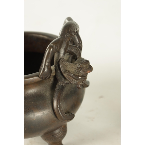 241 - A CHINESE PATINATED BRONZE CENSER WITH DRAGON HANDLES of squat bulbous form raised on shaped legs, i... 