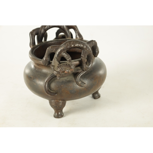 241 - A CHINESE PATINATED BRONZE CENSER WITH DRAGON HANDLES of squat bulbous form raised on shaped legs, i... 