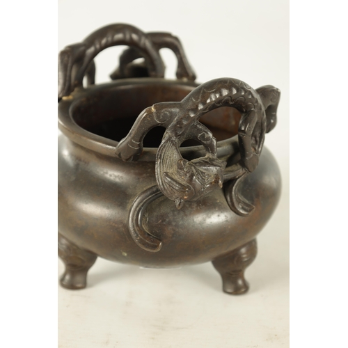 241 - A CHINESE PATINATED BRONZE CENSER WITH DRAGON HANDLES of squat bulbous form raised on shaped legs, i... 