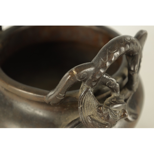 241 - A CHINESE PATINATED BRONZE CENSER WITH DRAGON HANDLES of squat bulbous form raised on shaped legs, i... 