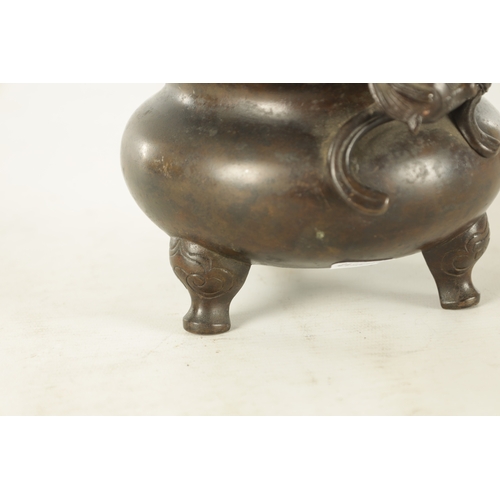 241 - A CHINESE PATINATED BRONZE CENSER WITH DRAGON HANDLES of squat bulbous form raised on shaped legs, i... 