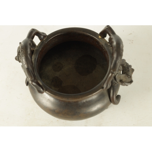 241 - A CHINESE PATINATED BRONZE CENSER WITH DRAGON HANDLES of squat bulbous form raised on shaped legs, i... 