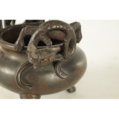 241 - A CHINESE PATINATED BRONZE CENSER WITH DRAGON HANDLES of squat bulbous form raised on shaped legs, i... 