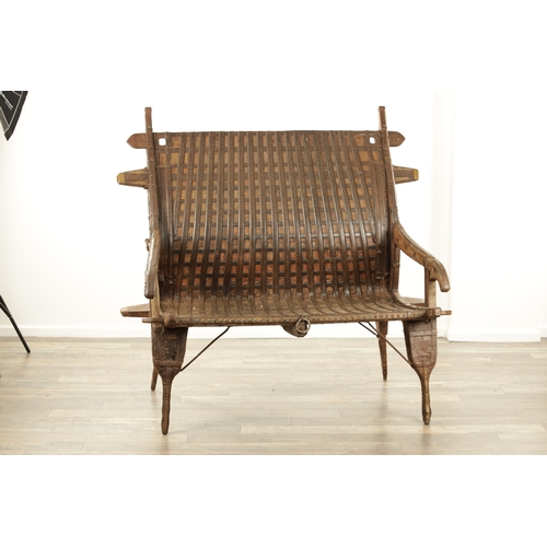 242 - AN 18TH CENTURY HINDU CHAIR, made from wood and iron with rivet decoration with various hooks and ho... 