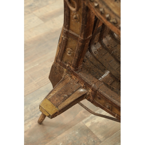 242 - AN 18TH CENTURY HINDU CHAIR, made from wood and iron with rivet decoration with various hooks and ho... 