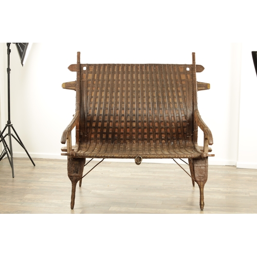 242 - AN 18TH CENTURY HINDU CHAIR, made from wood and iron with rivet decoration with various hooks and ho... 