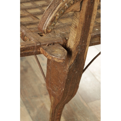 242 - AN 18TH CENTURY HINDU CHAIR, made from wood and iron with rivet decoration with various hooks and ho... 