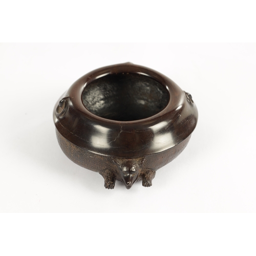 250 - A JAPANESE MEIJI PERIOD CARVED HARDWOOD BRUSH POT of shallow circular form modelled as a recumbent f... 