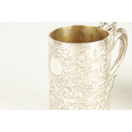 254 - A 19TH CENTURY CHINESE EXPORT SILVER MUG embossed with battle scenes depicting warriors on horseback... 