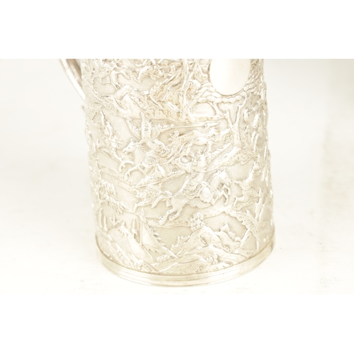 254 - A 19TH CENTURY CHINESE EXPORT SILVER MUG embossed with battle scenes depicting warriors on horseback... 