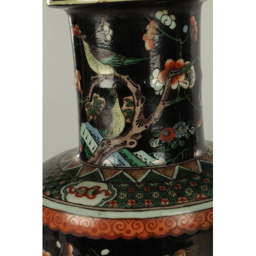 255 - A PAIR OF LATE 19TH CENTURY CHINESE FAMILLE NOIRE VASES decorated with birds amongst blossoming tree... 