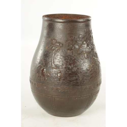 264 - A JAPANESE MEIJI PERIOD CAST IRON PATINATED VASE with relief moulded country scene with pagodas - si... 