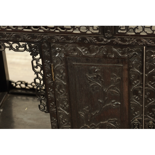 271 - A GOOD 19TH CENTURY CHINESE CARVED HARDWOOD DISPLAY CABINET with pierced and leaf-carved decoration ... 