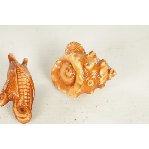 274 - TWO JAPANESE STAINED PLASTERWORK NETSUKE formed as a sweetcorn and a shell (5.5cm wide)