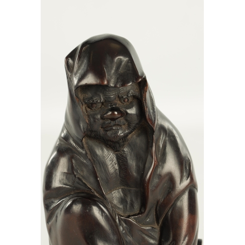 275 - A 19TH CENTURY JAPANESE CARVED HARDWOOD OKIMONO modelled as a standing Buddha, four character signat... 