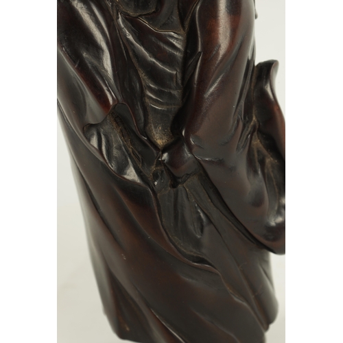 275 - A 19TH CENTURY JAPANESE CARVED HARDWOOD OKIMONO modelled as a standing Buddha, four character signat... 