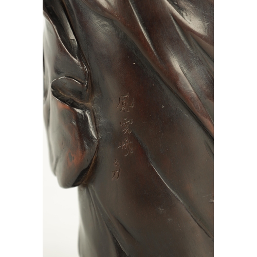 275 - A 19TH CENTURY JAPANESE CARVED HARDWOOD OKIMONO modelled as a standing Buddha, four character signat... 