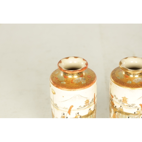 280 - A FINE PAIR OF JAPANESE MEIJI PERIOD SATSUMA CABINET VASES of cylindrical slender shape decorated wi... 