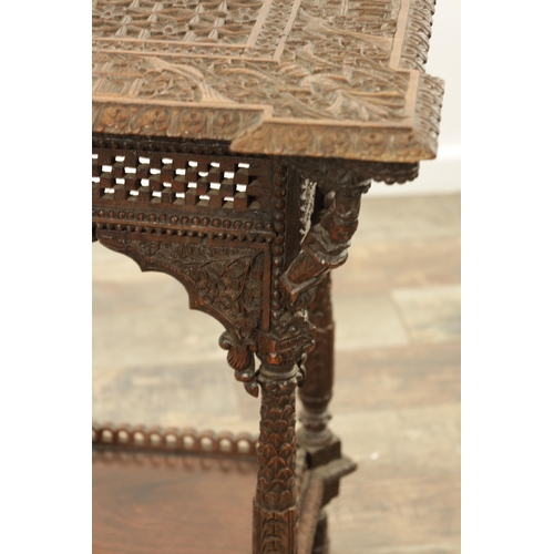 284 - A 19TH CENTURY INDIAN PROFUSELY CARVED HARDWOOD CENTRE TABLE the top with geometric flower head pane... 