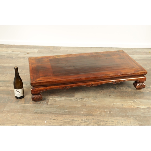 296 - A CHINESE STAINED ELM ALTER TABLE with panelled top above short-shaped scrolled feet (106cm wide 57c... 