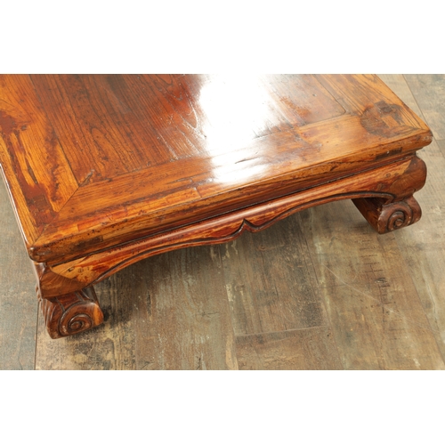 296 - A CHINESE STAINED ELM ALTER TABLE with panelled top above short-shaped scrolled feet (106cm wide 57c... 