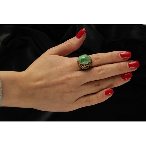 302 - A LADIES HEAVY 18CT GOLD JADE AND SAPPHIRE RING having a large jade cabochon above 38 sapphires in a... 