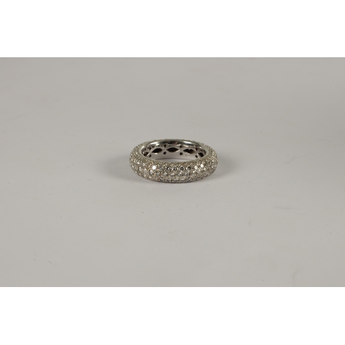 304 - A LADIES' WHITE GOLD AND DIAMOND ETERNITY RING diamond encrusted all over, the shank pierced to the ... 