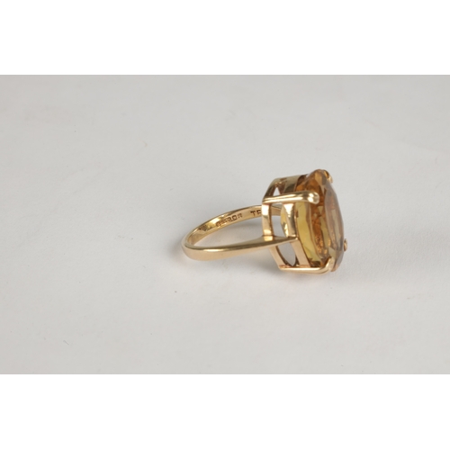 309 - A 9CT YELLOW GOLD AND CITRINE LADIES DRESS RING with raised open work claw set faceted oval stone - ... 